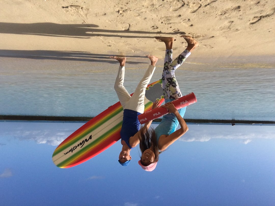 Masumi and Tedd on Waikiki Beach for yoga and surfing