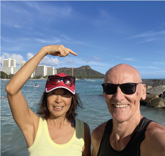 Tedd and Masumi pointing to Diamond Head in Waikiki, Hawaii