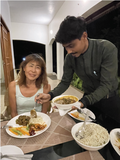 Masumi being served dinner on the veranda of the Kochi historic villa hotel in Kerala